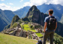 Youthful backpacker at אטרקציות באולנטייטמבו פרו with Incan ruins and mountains